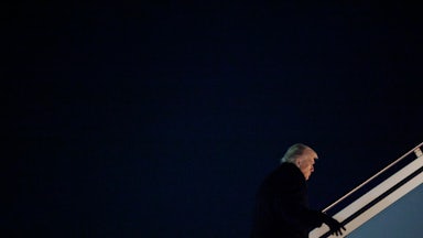 Donald Trump walks up the stairs to board Air Force One