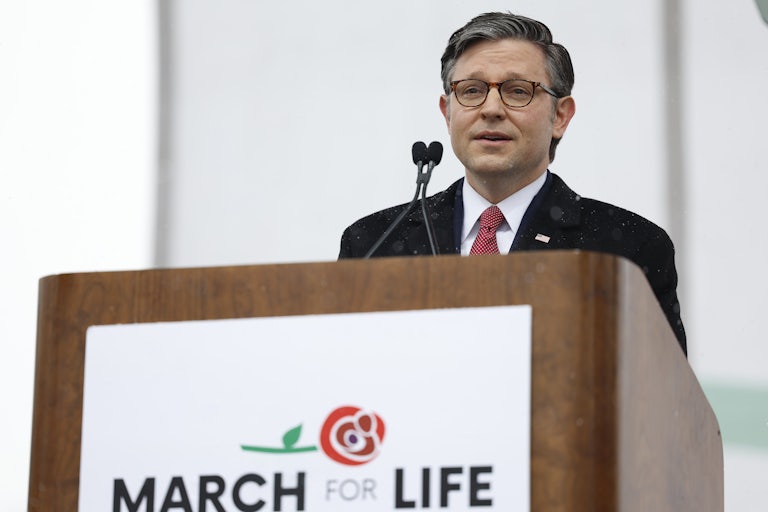 Mike Johnson stands behind a lectern at the March for Life
