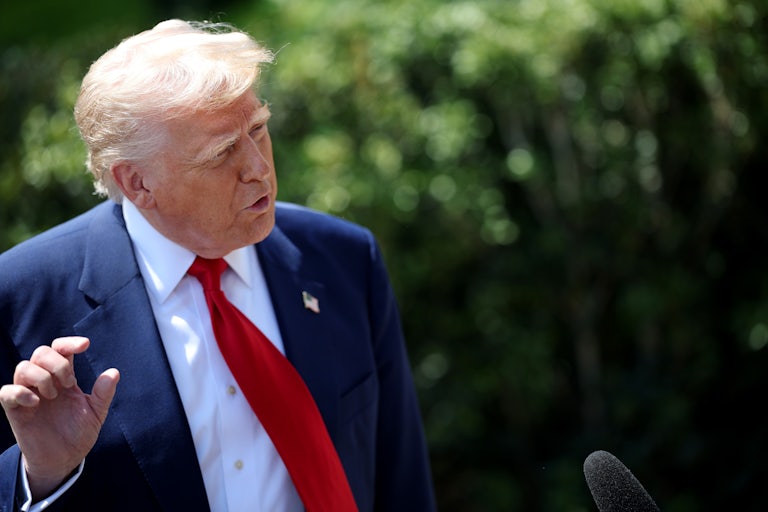 Donald Trump speaks to a reporter (not pictured) and makes a hand gesture as if it to say something is small.