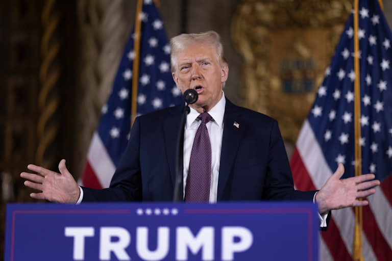 Donald Trump gestures while speaking at a podium