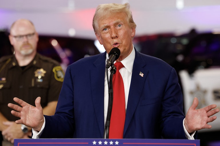Donald Trump gestures while speaking at a campaign event near Detroit, Michigan