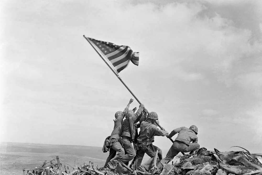 Six U.S. Marines raise an American flag atop Mount Suribachi on Iwo Jima during World War II.