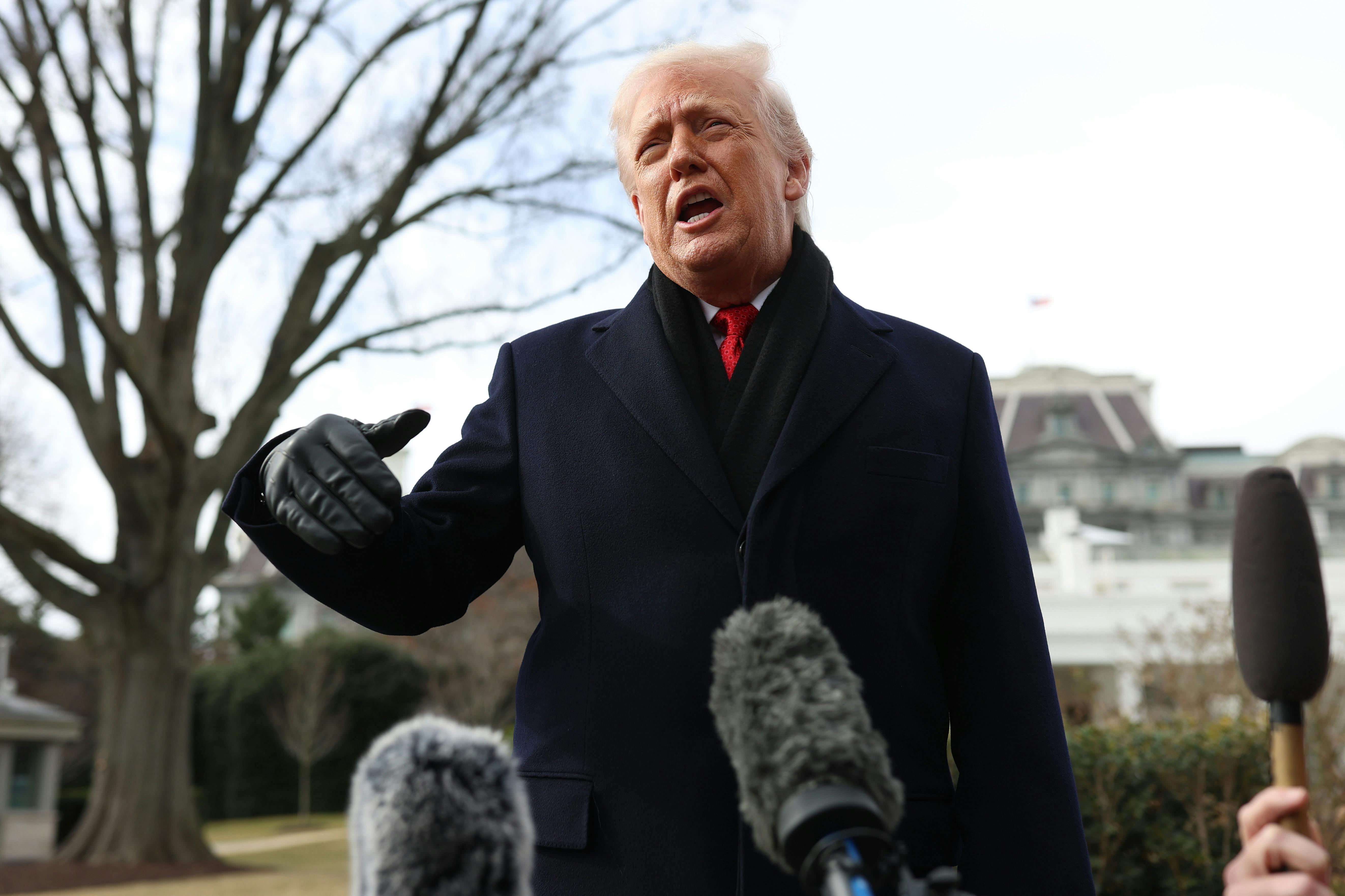 Donald Trump speaks to reporters outside the White House.