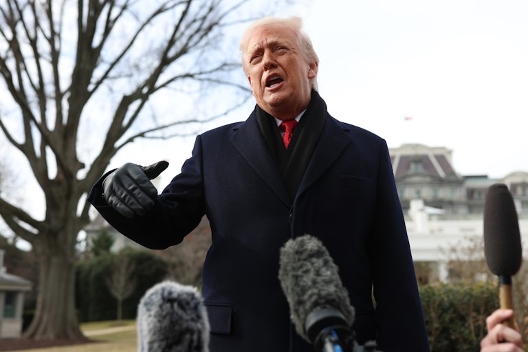 Donald Trump speaks to reporters outside the White House.