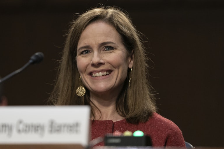 Amy Coney Barrett smiles while testifying before the Senate Judiciary Committee. 