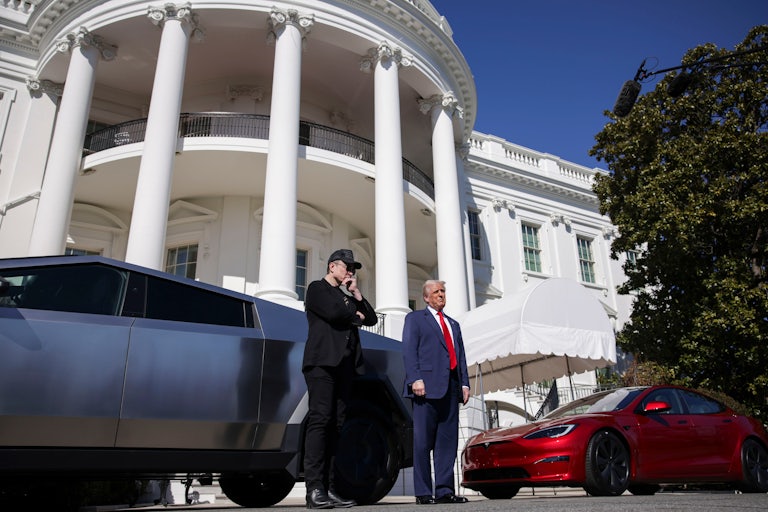 Elon Musk and Donald Trump stand in front of a Cybertruck and a Tesla Model S outside the White House