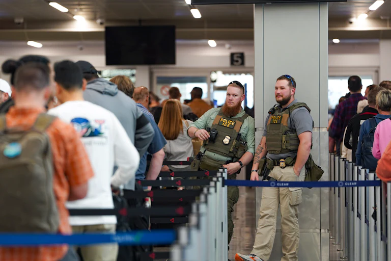 ICE agents stand next to a security line at Hartsfield-Jackson Atlanta International Airport