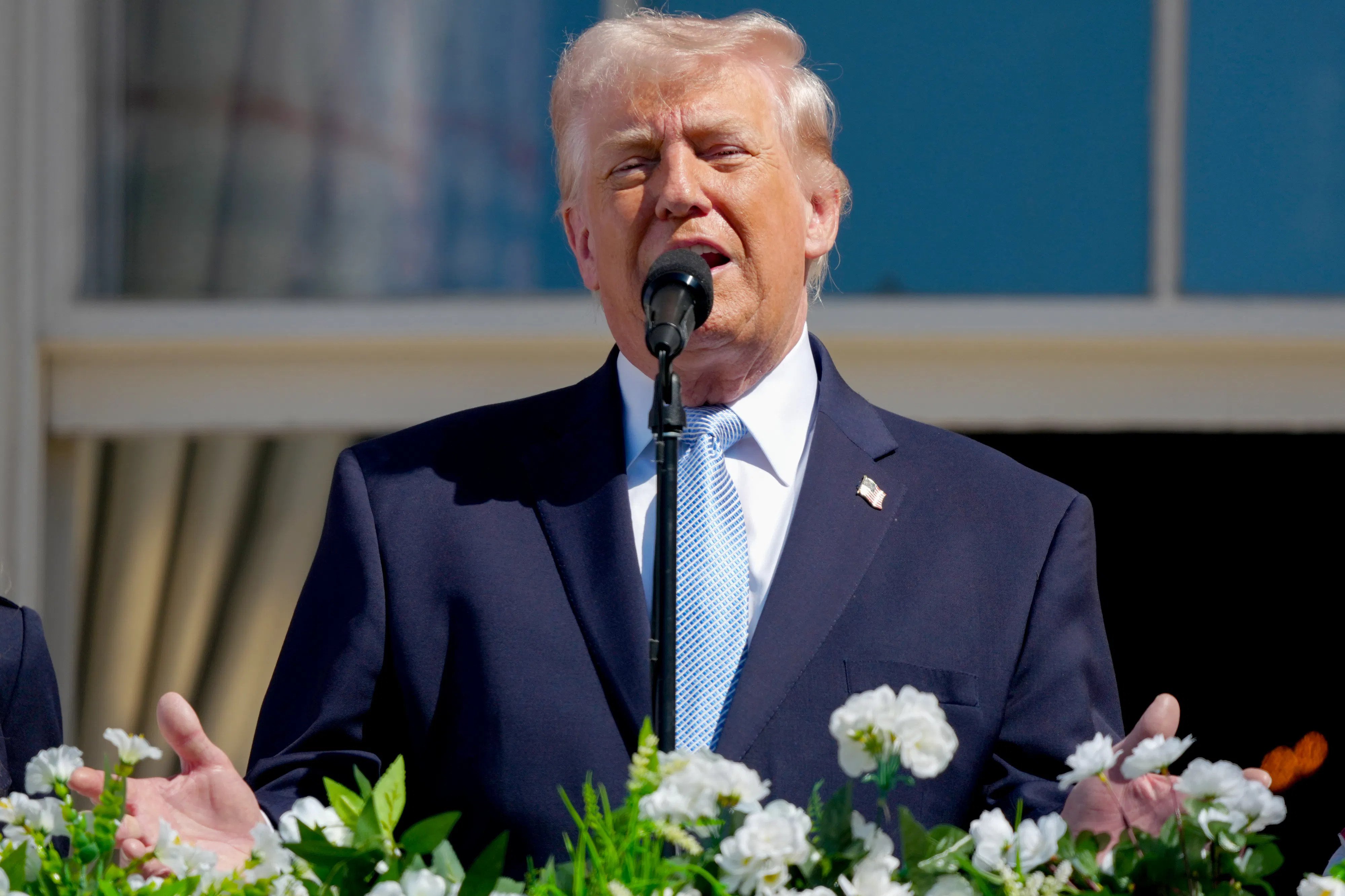 Donald Trump gestures while speaking from the White House balcony