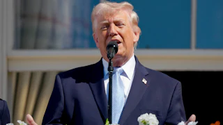 Donald Trump gestures while speaking from the White House balcony