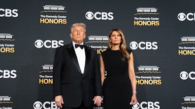 Donald and Melania Trump stand in front of a backdrop that reads "CBS" and "Kennedy Center Honors."