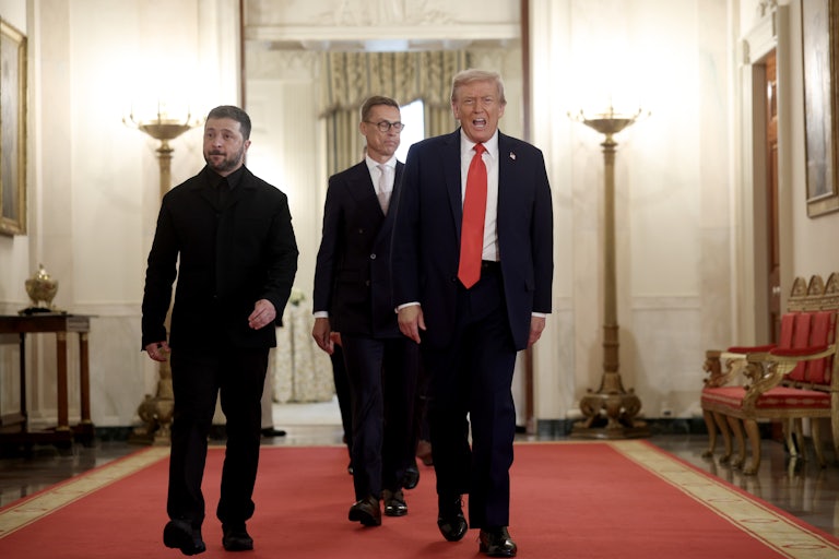 President Trump walks down the hallway of the White House, flanked by foreign heads of state.
