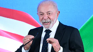 Brazilian President Luiz Inácio Lula da Silva (Lula) gestures while speaking at a podium during a press conference