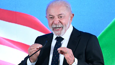 Brazilian President Luiz Inácio Lula da Silva (Lula) gestures while speaking at a podium during a press conference