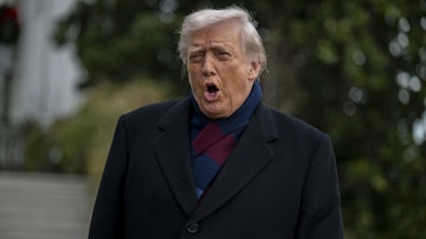 Donald Trump speaks while standing outside the White House