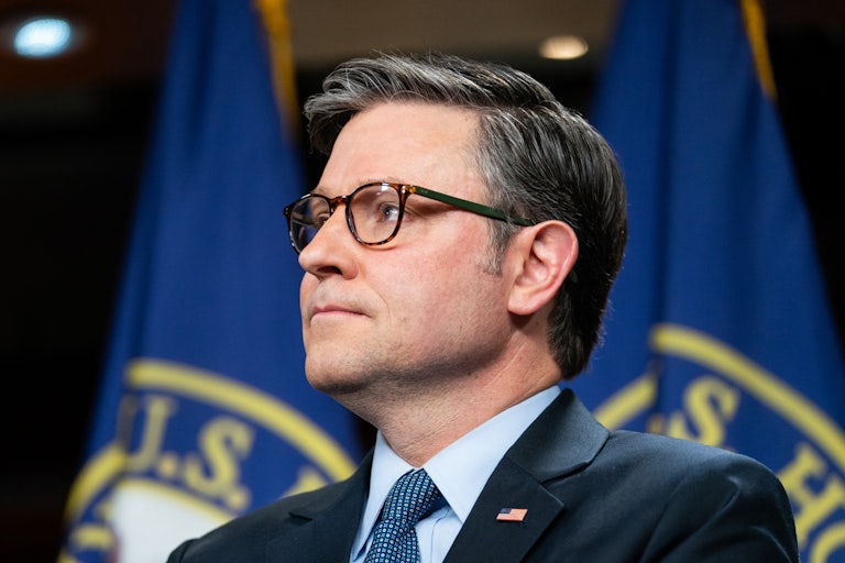 Mike Johnson looks up during a press conference