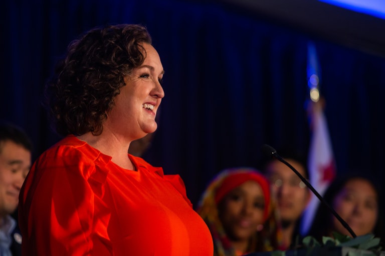Katie Porter smiles at a podium