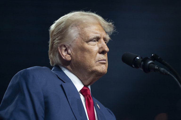 Donald Trump stands in front of a microphone during a campaign event