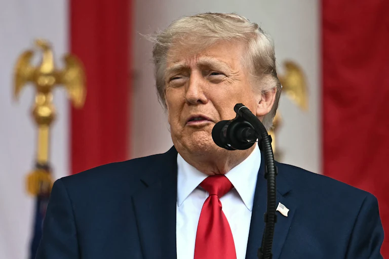 Donald Trump speaks into a microphone