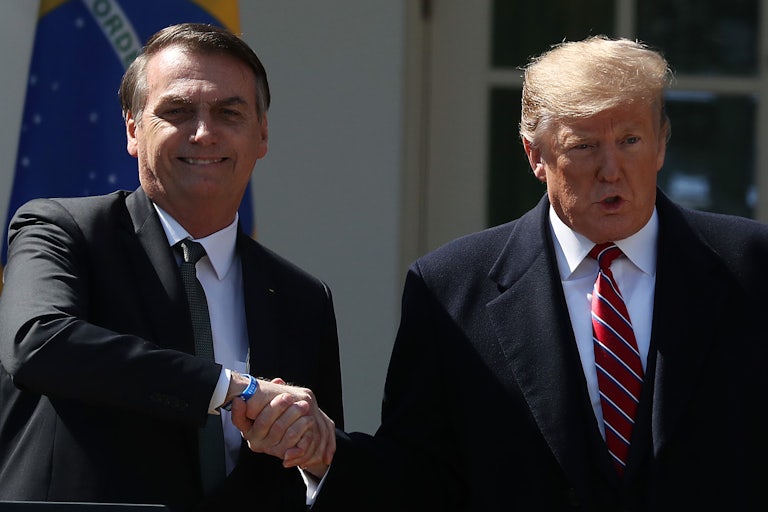 Jair Bolsonaro and Donald Trump shake hands. This is an old photo from Donald Trump’s first term as president.