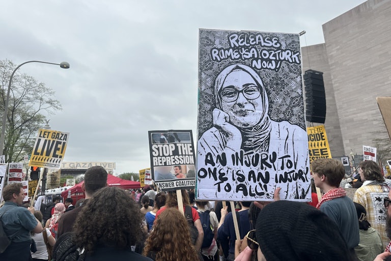 A protest where people hold signs reading "Release Rumeysa Ozturk now" and "Let Gaza live."