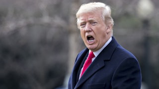 Donald Trump yells to members of the media.