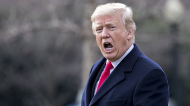 Donald Trump yells to members of the media.