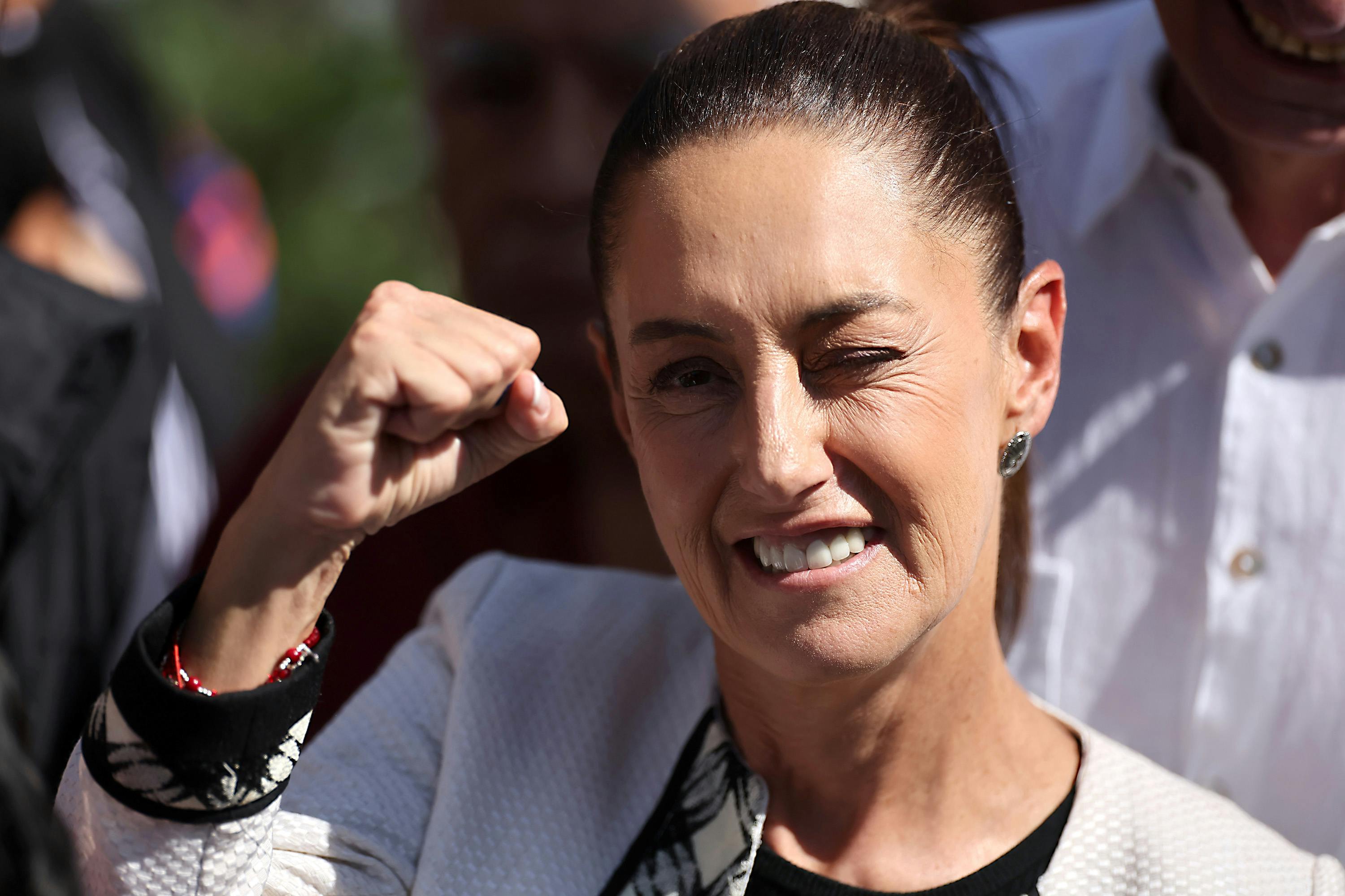 Claudia Sheinbaum raises her fist before casting her vote in Mexico City 