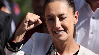 Claudia Sheinbaum raises her fist before casting her vote in Mexico City