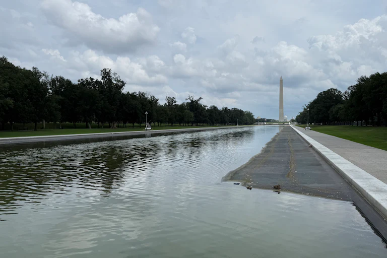 The Lincoln Memorial Reflecting Pool on July 13, partially drained, showing what appear to be tire marks at the bottom