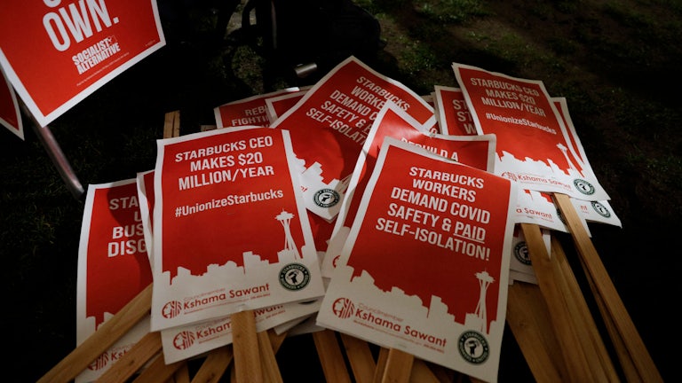 Picket signs are pictured at a rally in support of workers of two Seattle Starbucks locations that announced plans to unionize.