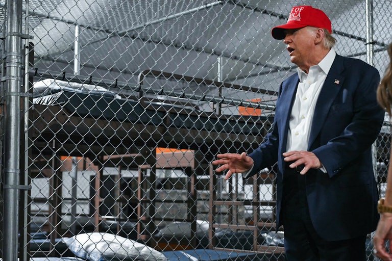 Donald Trump gestures while speaking during a visit to the ICE detention facility "Alligator Alcatraz" with Kristi Noem and Ron DeSantis