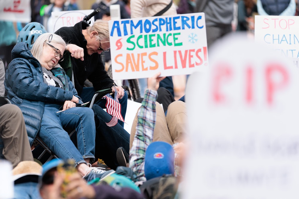 On May 1, demonstrators in Boulder staged a “die-in” near the entrance to the National Oceanic and Atmospheric Administration and the National Institute of Standards and Technology to show their support for federal science agencies. One sign reads "Atmospheric science saves lives."