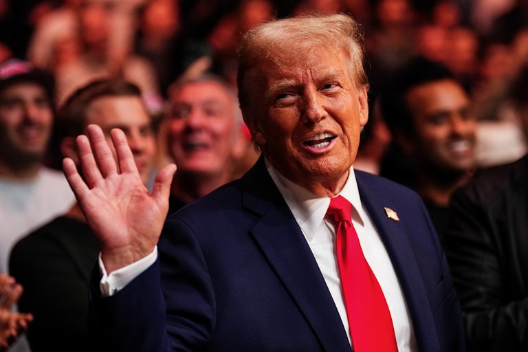 Donald Trump smiles and waves