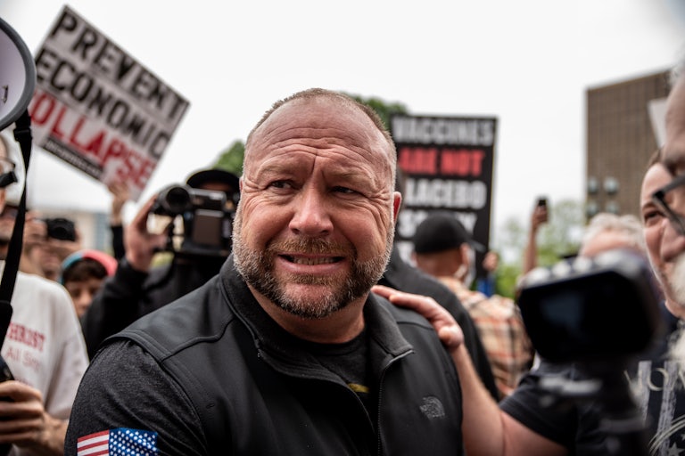 Alex Jones grimaces while at a protest in Texas