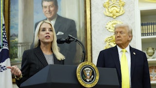 Attorney General Pam Bondi speaks at a lectern in the Oval Office of the White House, while President Trump looks on.