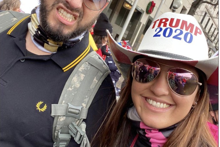 Barbara Balmaseda smiles with sunglasses and a Trump 2020 hat. A man beside her grimaces.