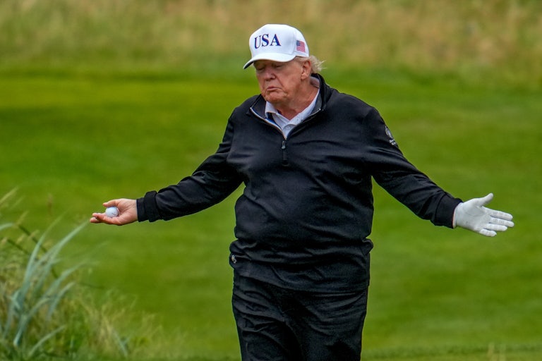 Donald Trump shrugs while standing on his golf course in Turnberry, Scotland.