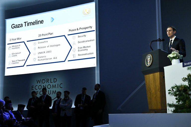 Jared Kushner speaks as a “Gaza Timeline” is displayed on a giant screen next to him.