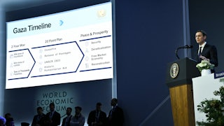 Jared Kushner speaks as a “Gaza Timeline” is displayed on a giant screen next to him.