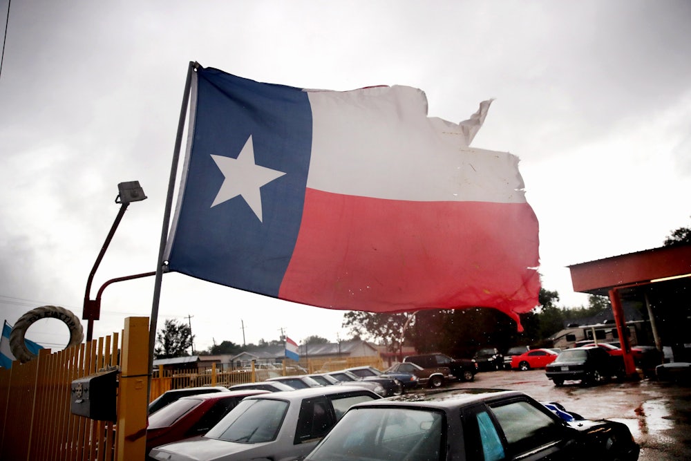 A torn state flag of Texas hangs on a staff in Houston.