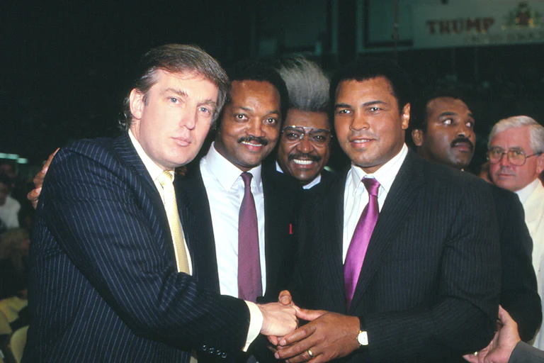 Donald Trump, Jesse Jackson, Don King, and Muhammad Ali smile in a black and white photo.