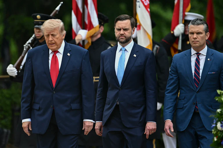 President Donald Trump, Vice President JD Vance, and Defense Secretary Pete Hegseth stand side by side, looking down.