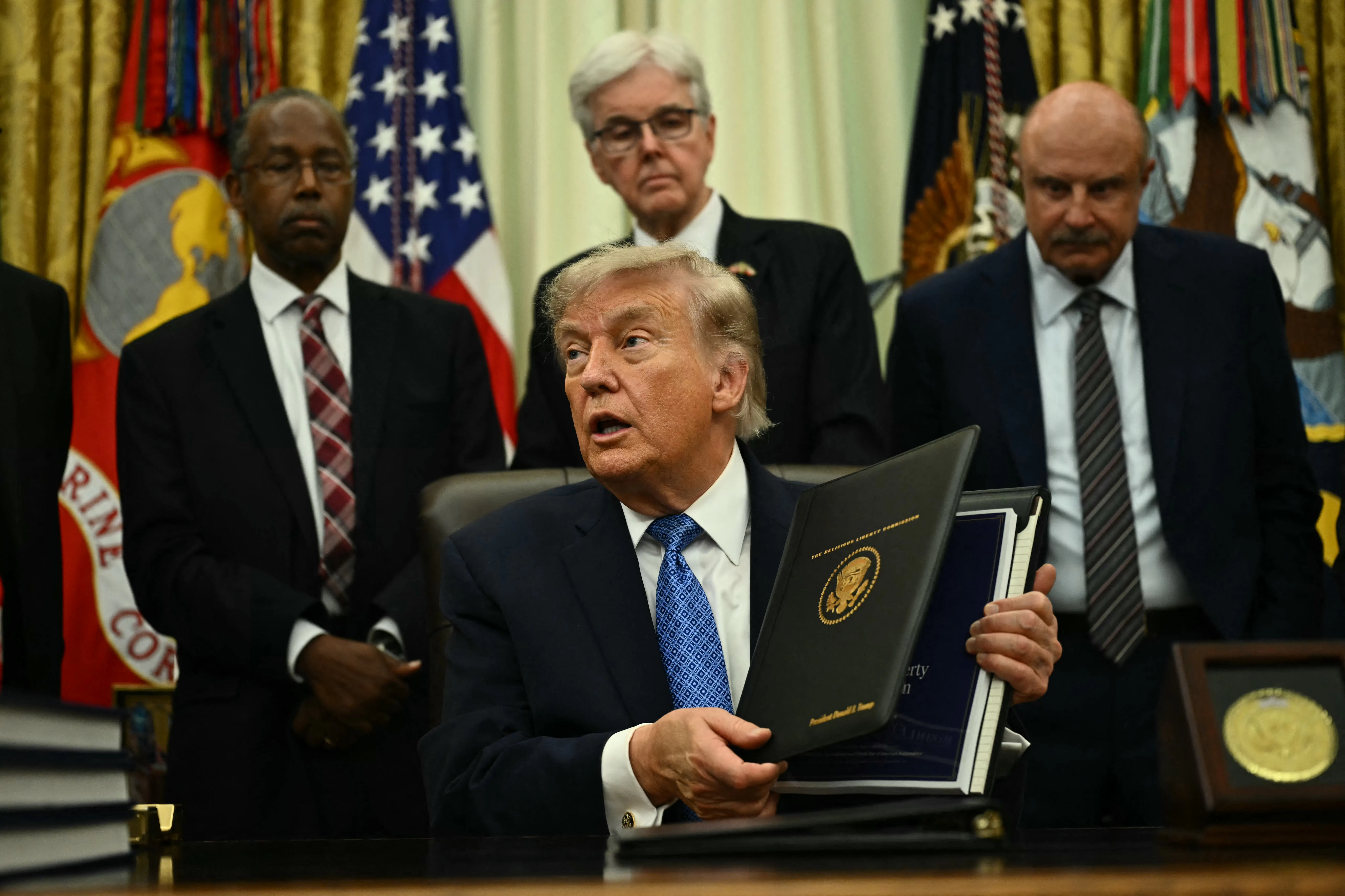 Donald Trump presents findings of his Religious Liberty Commission in the Oval Office of the White House.