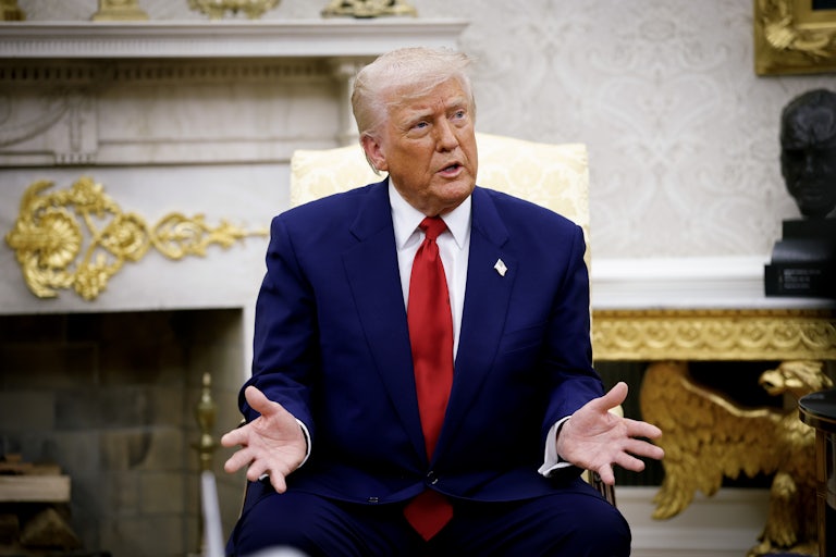 Donald Trump sits in the White House and spreads his hands out, as if in exasperation or confusion.