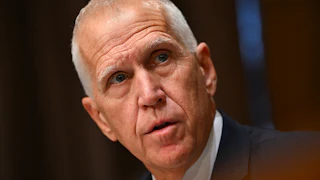 Senator Thom Tillis looks to the side while speaking during a Senate committee hearing