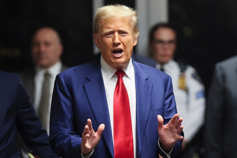 Donald Trump talks while gesturing with both hands