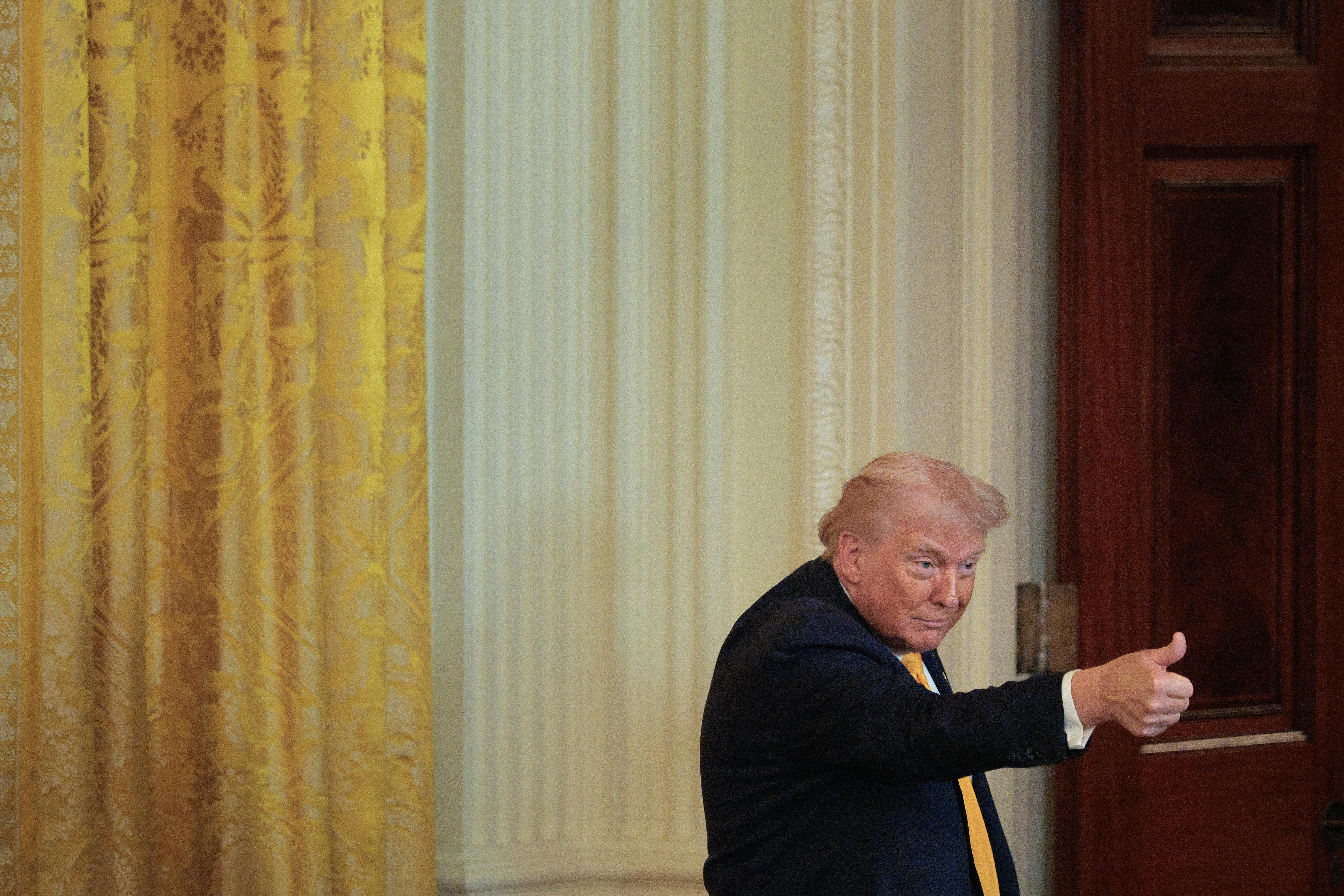 Donald Trump gives a thumbs up during an event at the White House