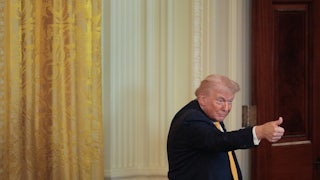 Donald Trump gives a thumbs up during an event at the White House