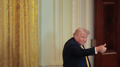 Donald Trump gives a thumbs up during an event at the White House