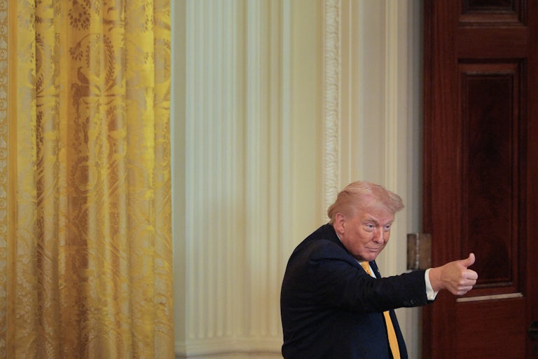 Donald Trump gives a thumbs up during an event at the White House
